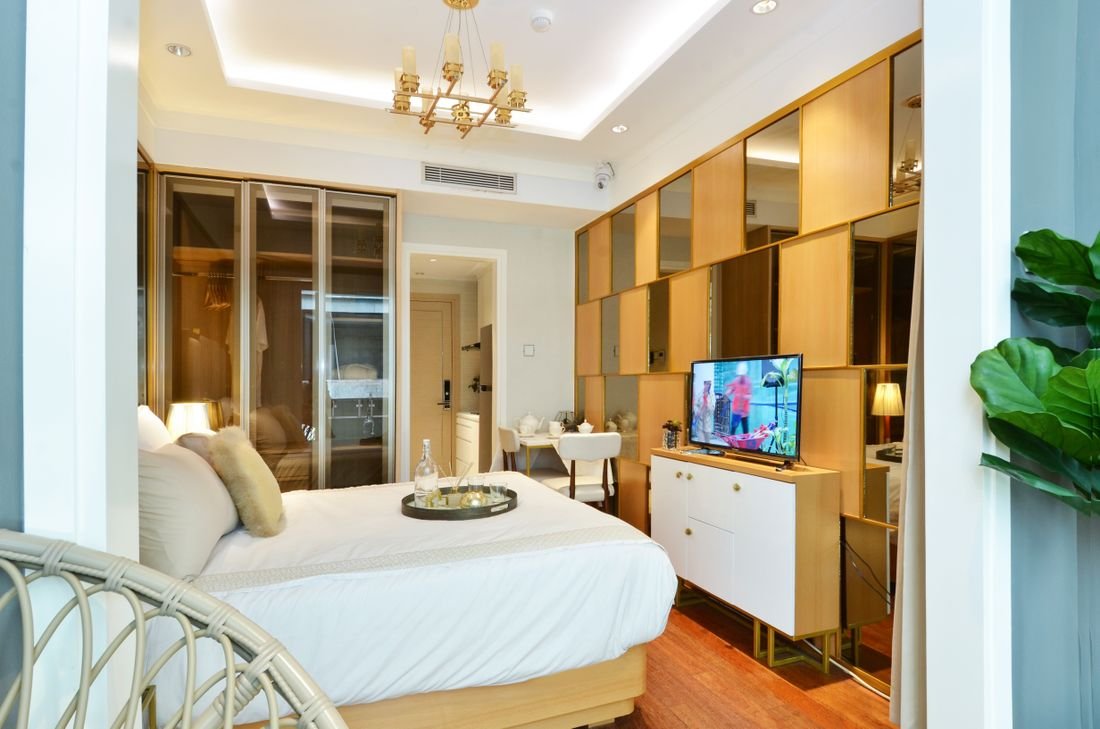 Made bed with white linen in a bright bedroom