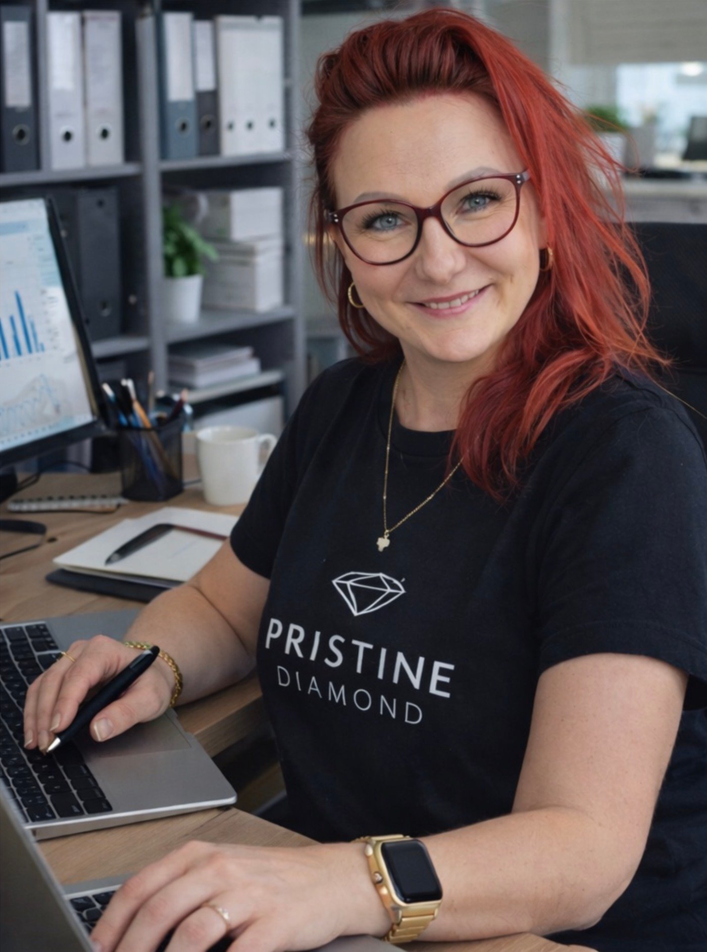 The founder at her desk, wearing a Pristine Diamond t-shirt